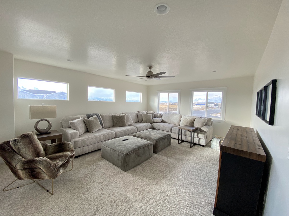 Living room with a large sectional and high windows