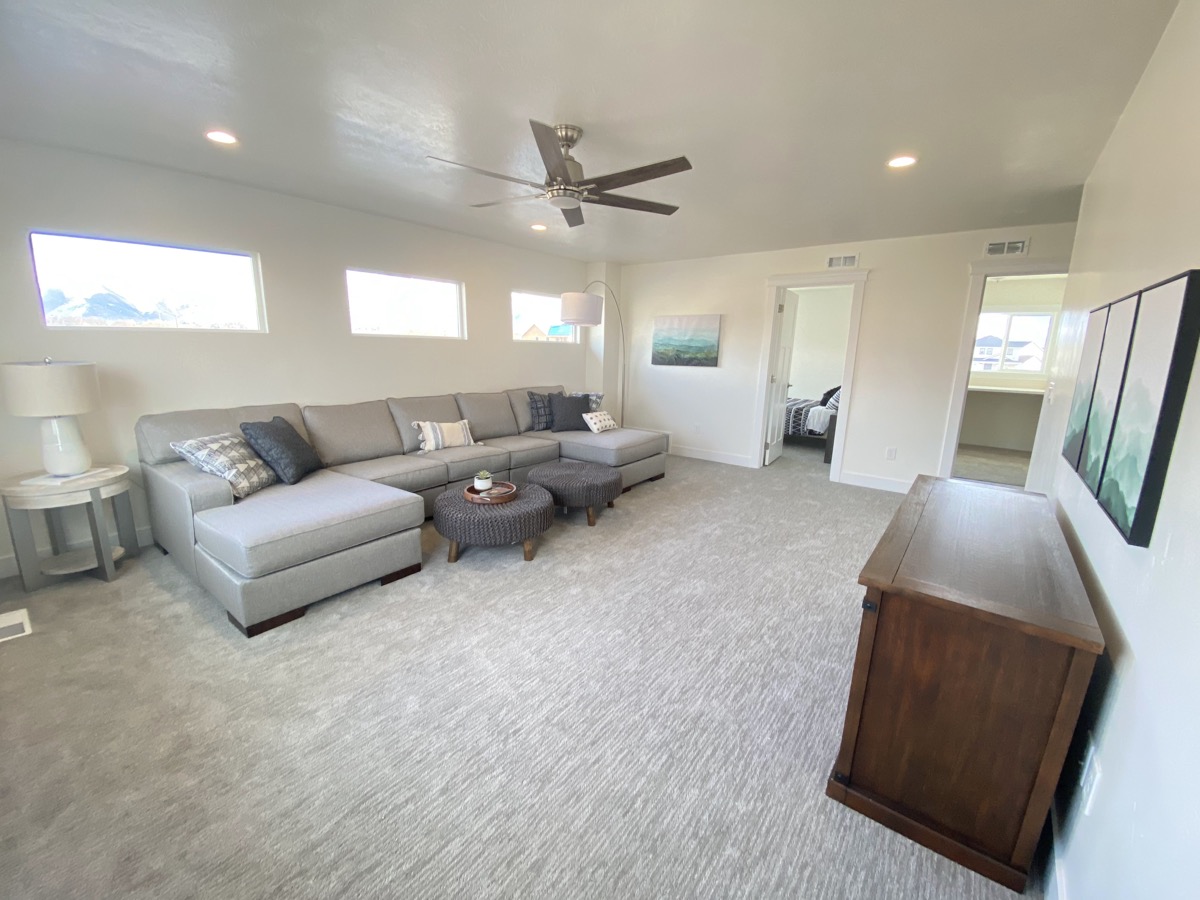Wide family room with a large sectional and media console
