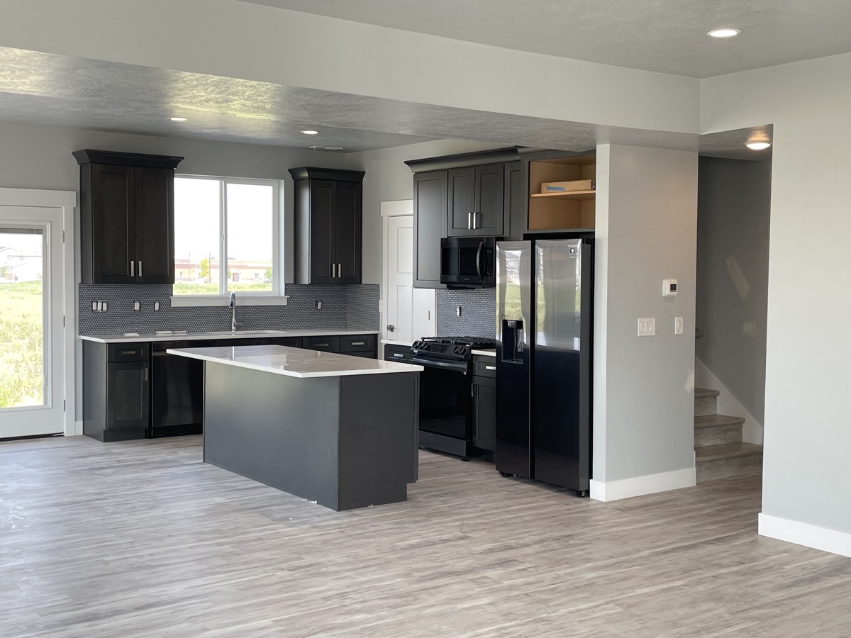 Kitchen with dark cabinetry and a dark center island
