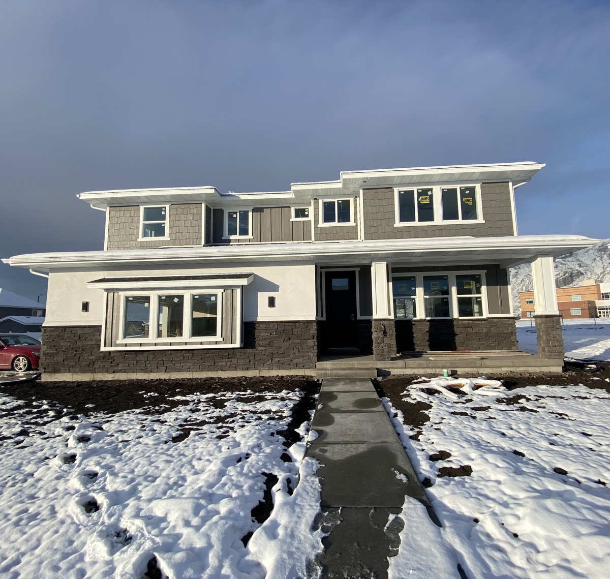 Gray and white two level home in a winter mountain setting