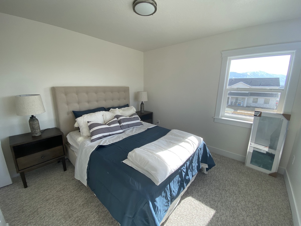 Bedroom with blue bedding and natural light