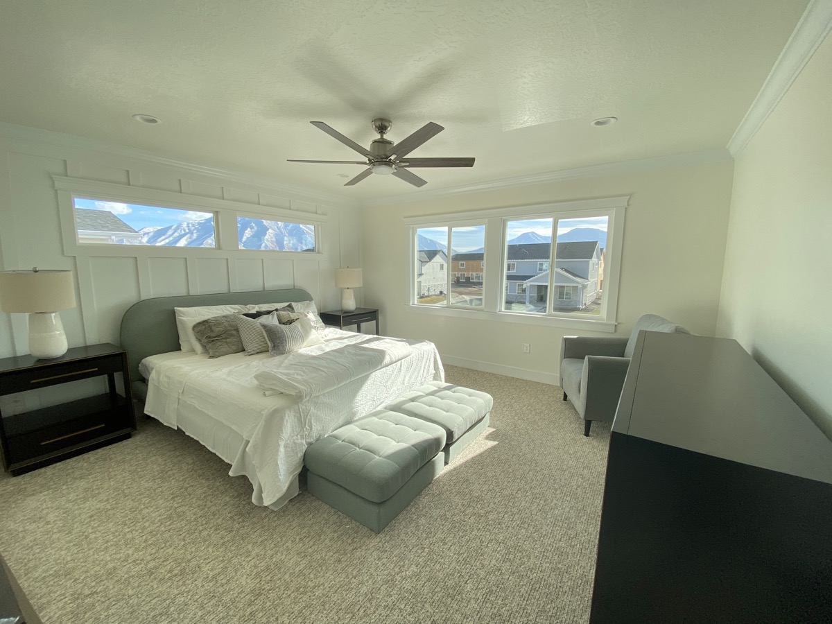 Primary bedroom with neutral seating and mountain views