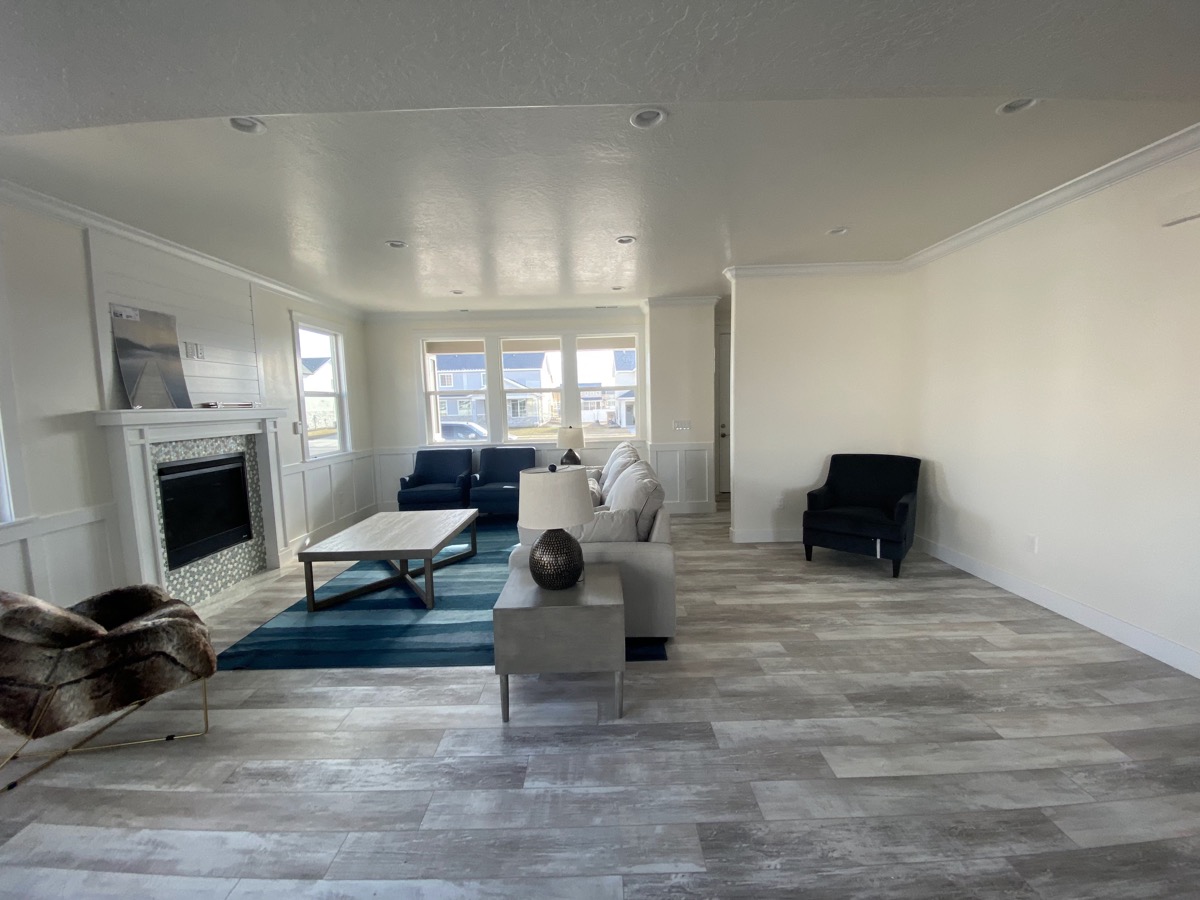 Open living room with fireplace and blue seating